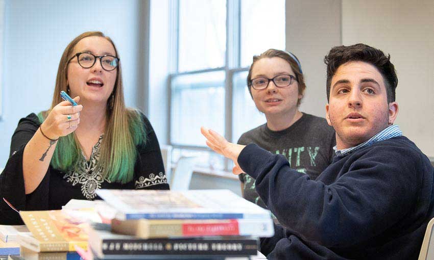 Three students work on a project together